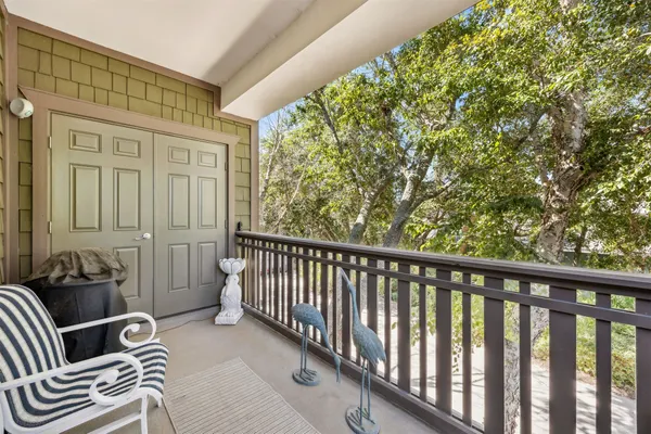 a balcony with furniture and wooden floor