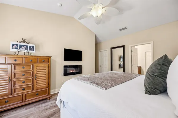 a spacious bedroom with a bed and a chandelier