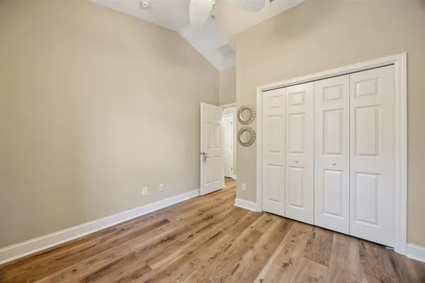 a view of an empty room with wooden floor