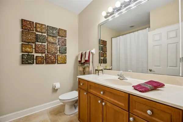 a bathroom with a sink vanity granite and toilet