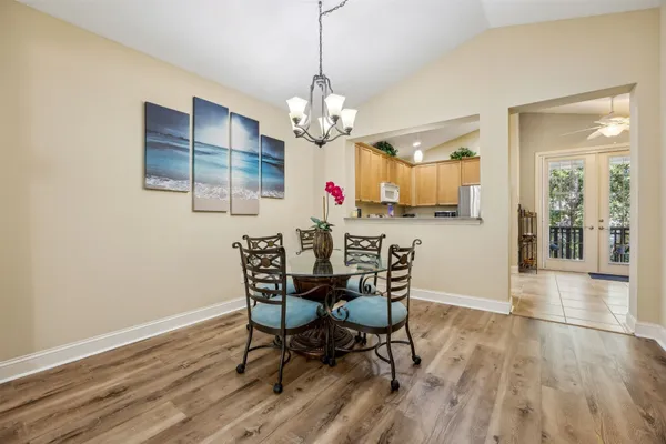a view of a dining room with furniture wooden floor and chandelier