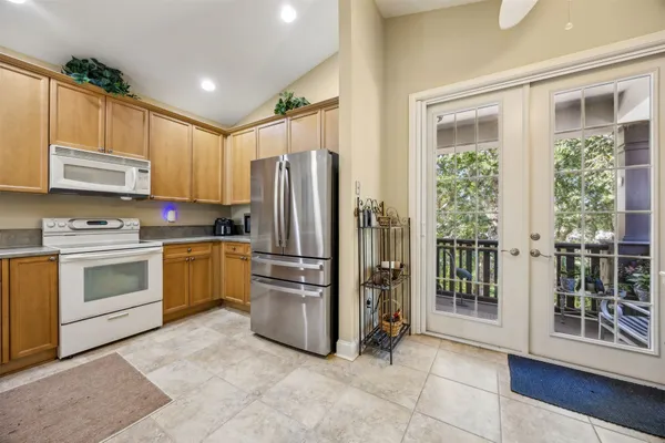 a kitchen with stainless steel appliances a refrigerator sink and cabinets
