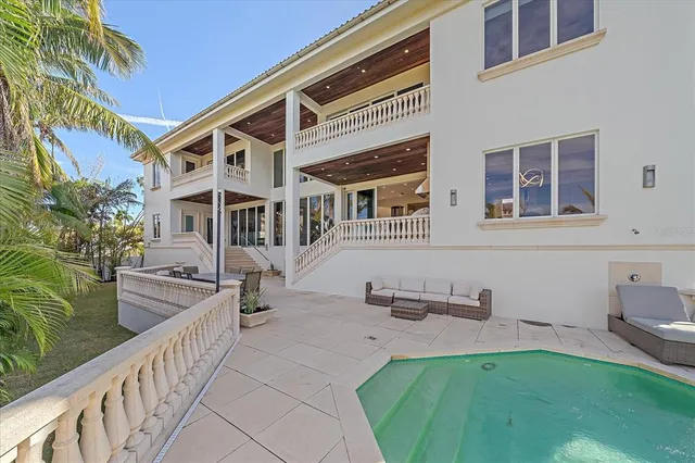 a living room with furniture a large window and a potted plant