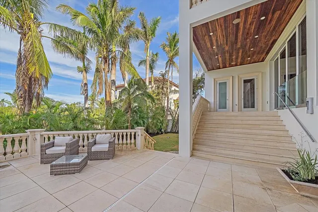 a living room with furniture and a view of kitchen