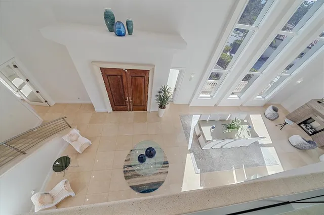 a kitchen with stainless steel appliances granite countertop a sink and a large window