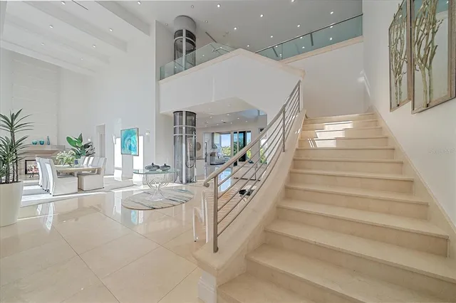 a kitchen with stainless steel appliances granite countertop a sink and a large window