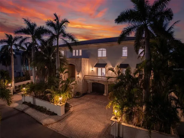 a view of an house with backyard and sitting area