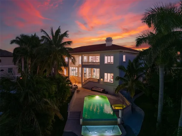 a view of a patio with table and chairs with wooden floor and fence