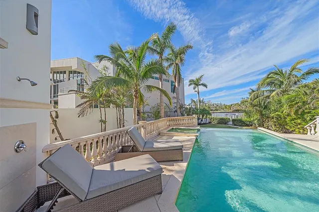 a living room with furniture a large window and a potted plant