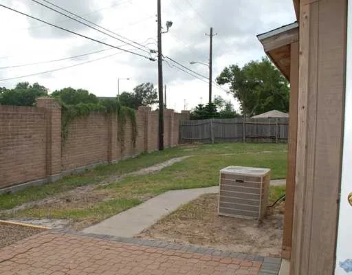 a view of a backyard with plants and a lake view
