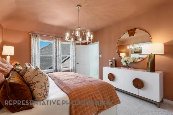 a bedroom with a bed and a chandelier