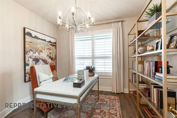 a living room with furniture a bookshelf and a window