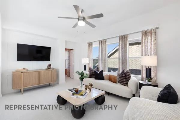 a bedroom with furniture and a flat screen tv