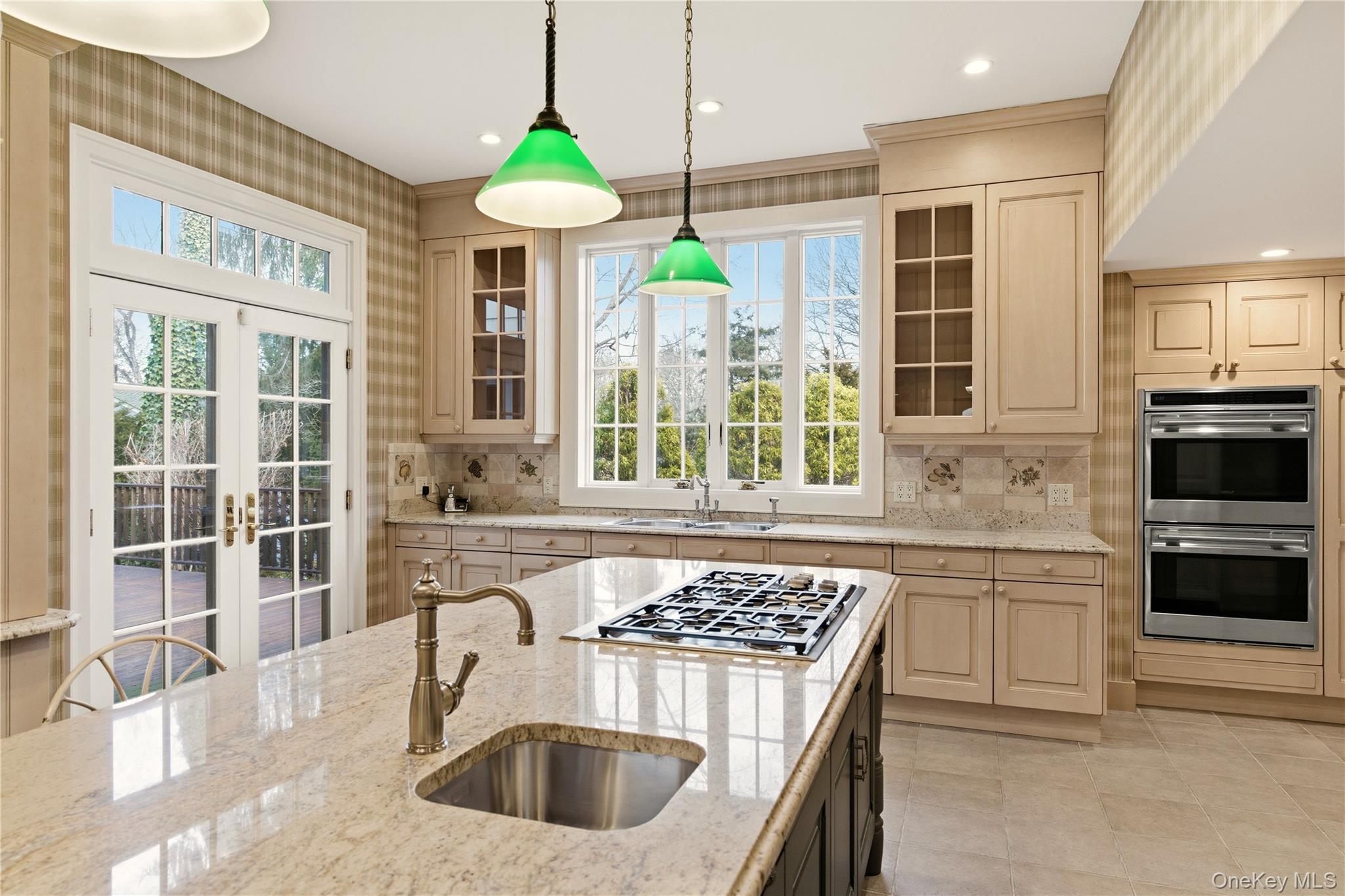 104 Fort Hill Road Huntington, NY 11743 - Photo 11 of 32 a kitchen with stainless steel appliances a stove a sink a microwave a dining table and chairs