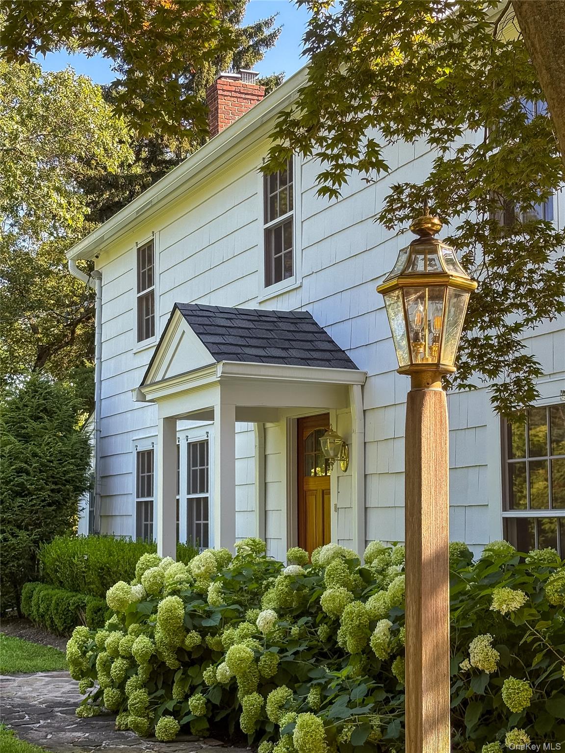104 Fort Hill Road Huntington, NY 11743 - Photo 3 of 32 a front view of a house with garden