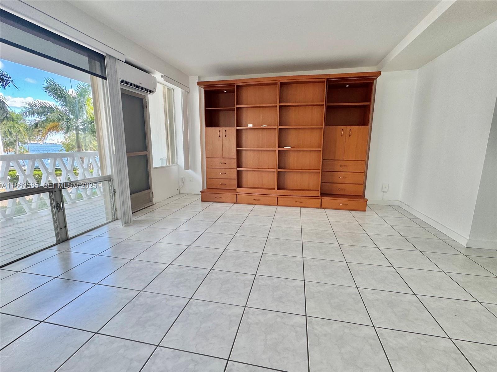 1430 Brickell Bay Drive, Unit 301 Miami, FL 33131 - Photo 1 of 18 a view of empty room with wooden floor and windows