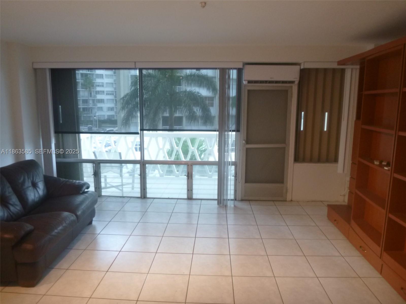 1430 Brickell Bay Drive, Unit 301 Miami, FL 33131 - Photo 11 of 18 a view of livingroom with furniture and window