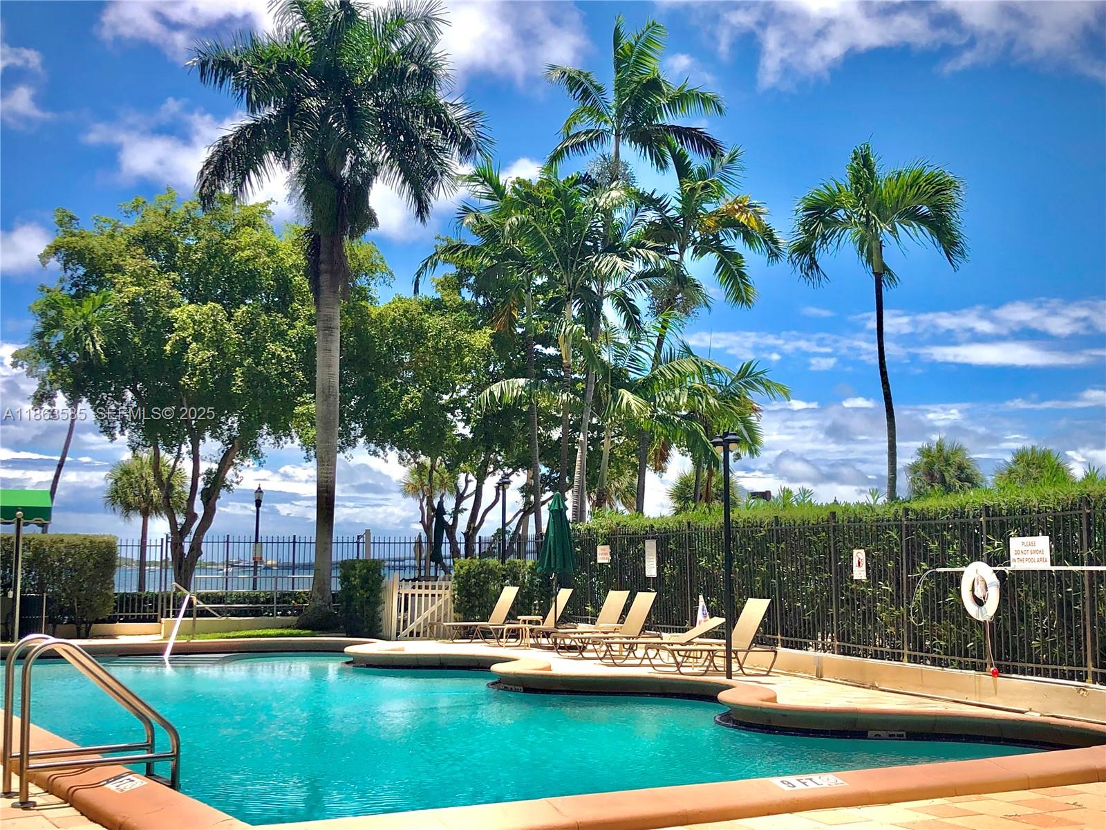 1430 Brickell Bay Drive, Unit 301 Miami, FL 33131 - Photo 17 of 18 a view of swimming pool with outdoor seating