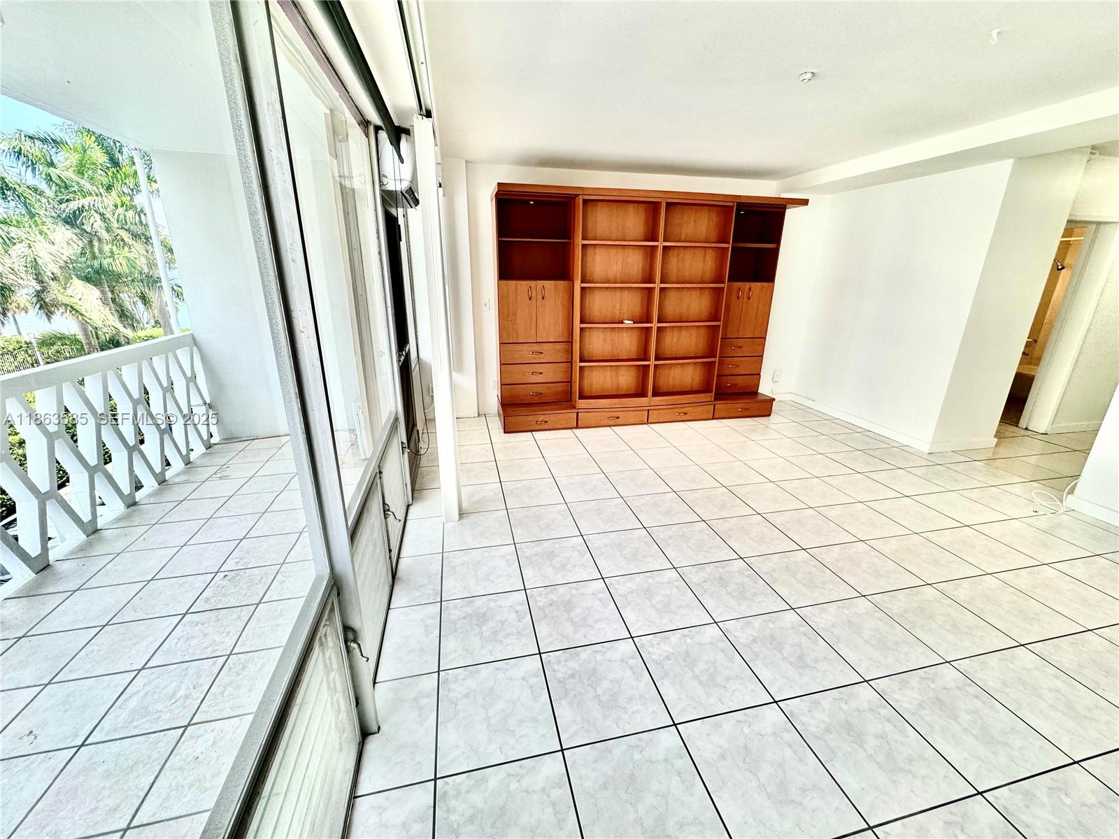 1430 Brickell Bay Drive, Unit 301 Miami, FL 33131 - Photo 5 of 18 an empty room with windows