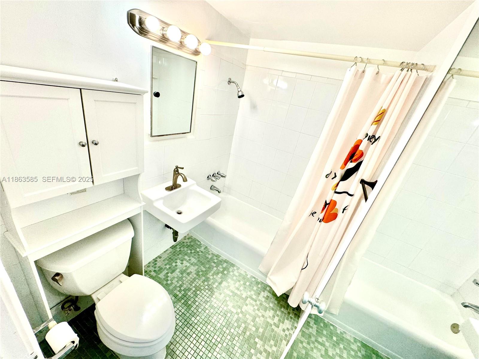 1430 Brickell Bay Drive, Unit 301 Miami, FL 33131 - Photo 10 of 18 a bathroom with a sink toilet and shower
