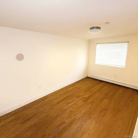 an empty room with wooden floor