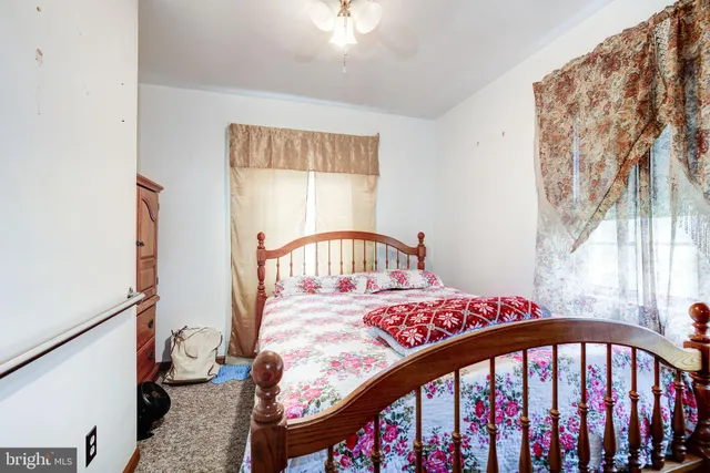 a bedroom with a bed and a small table