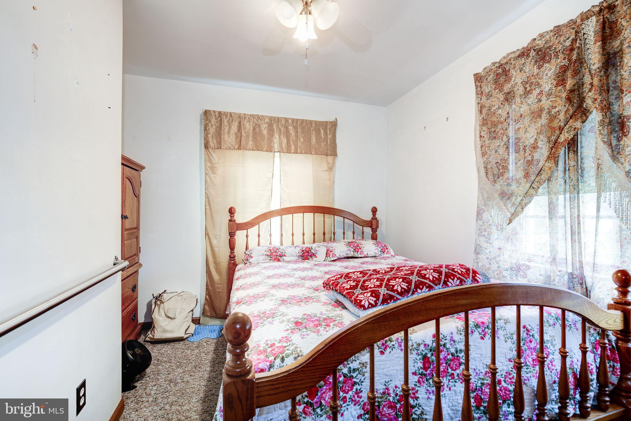 11907 Lime Plant Road New Market, MD 21774 - Photo 24 of 47 a bedroom with a bed and a small table