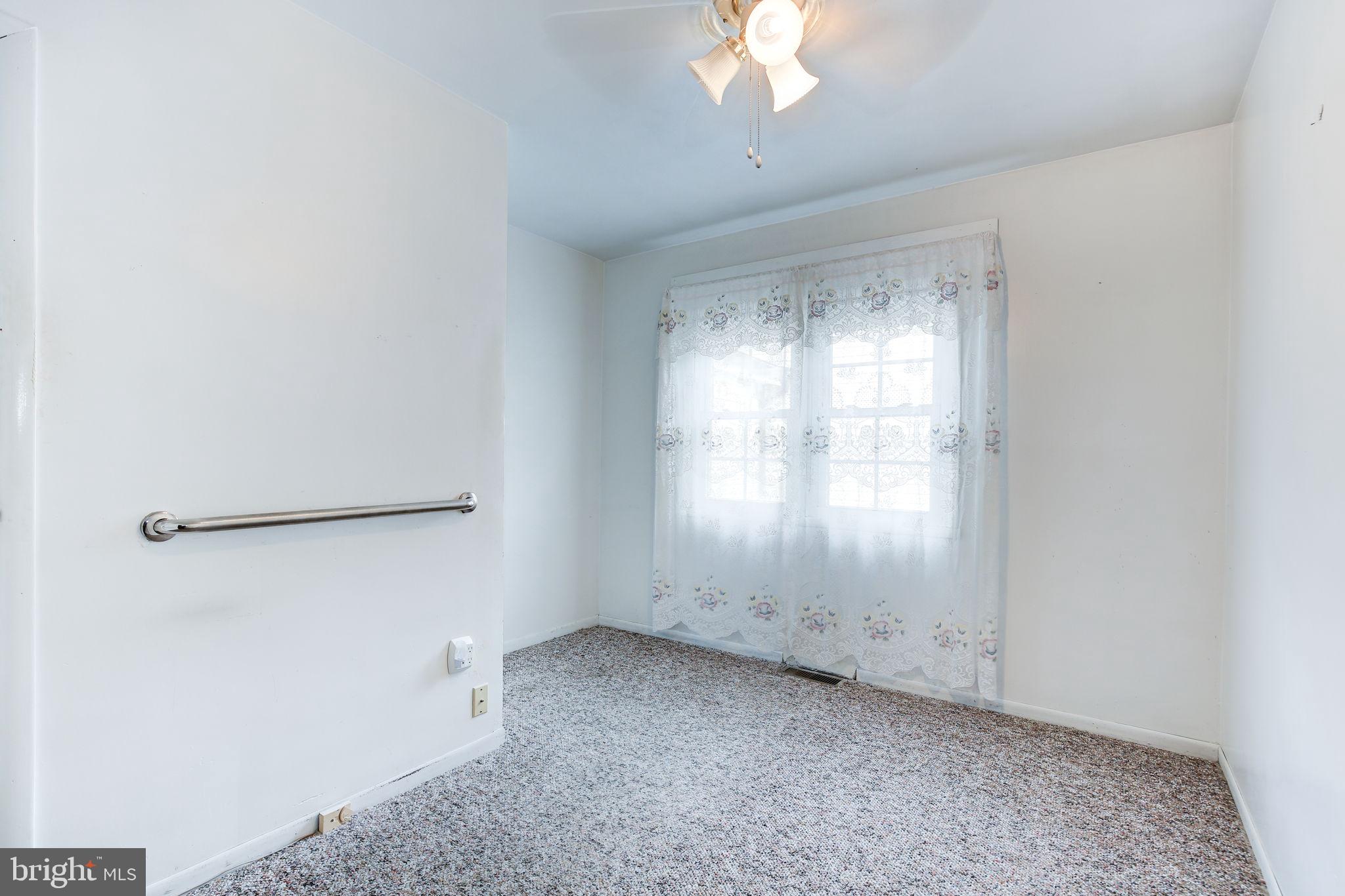 11907 Lime Plant Road New Market, MD 21774 - Photo 31 of 47 an empty room with a chandelier fan and windows