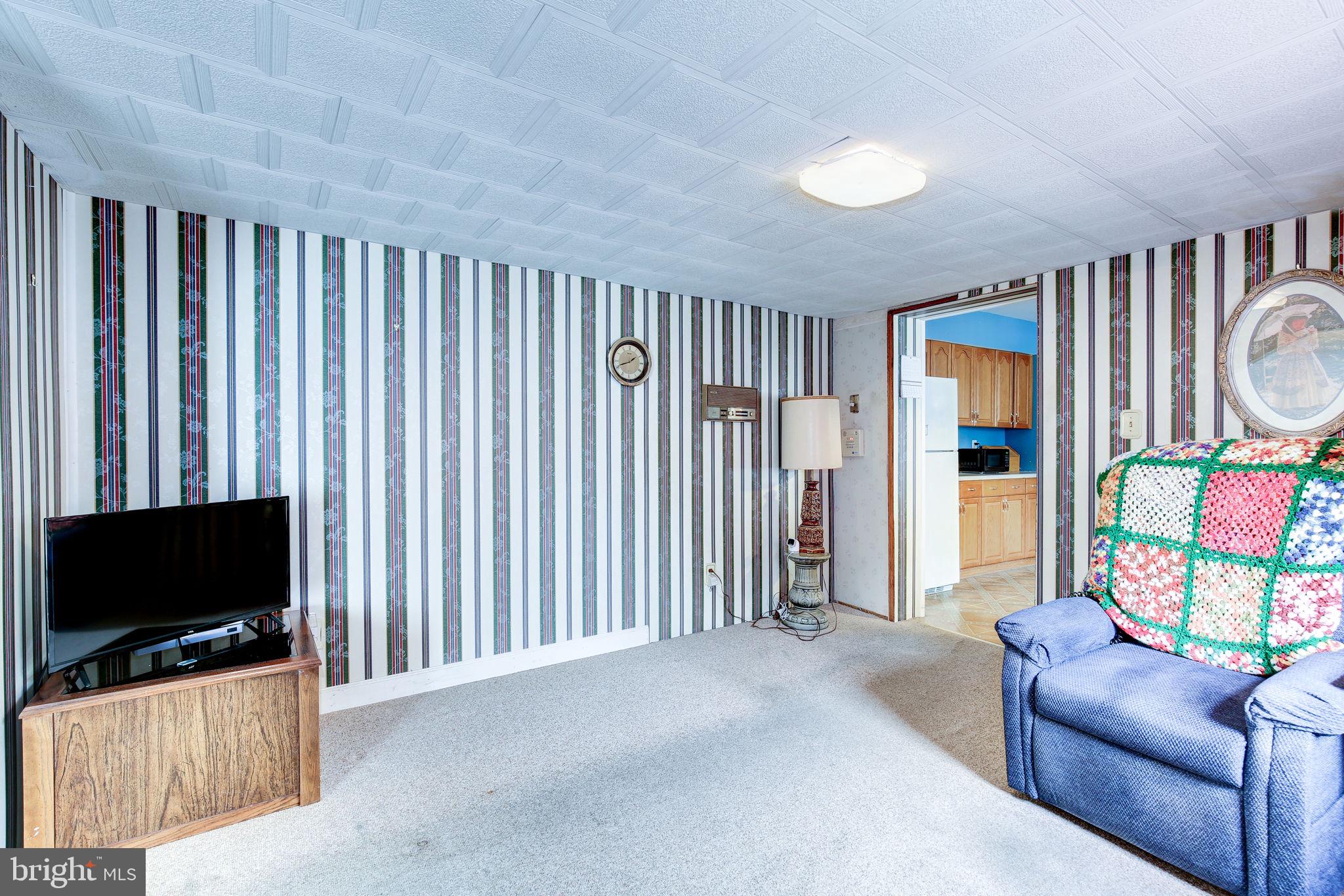 11907 Lime Plant Road New Market, MD 21774 - Photo 37 of 47 a living room with furniture and a flat screen tv