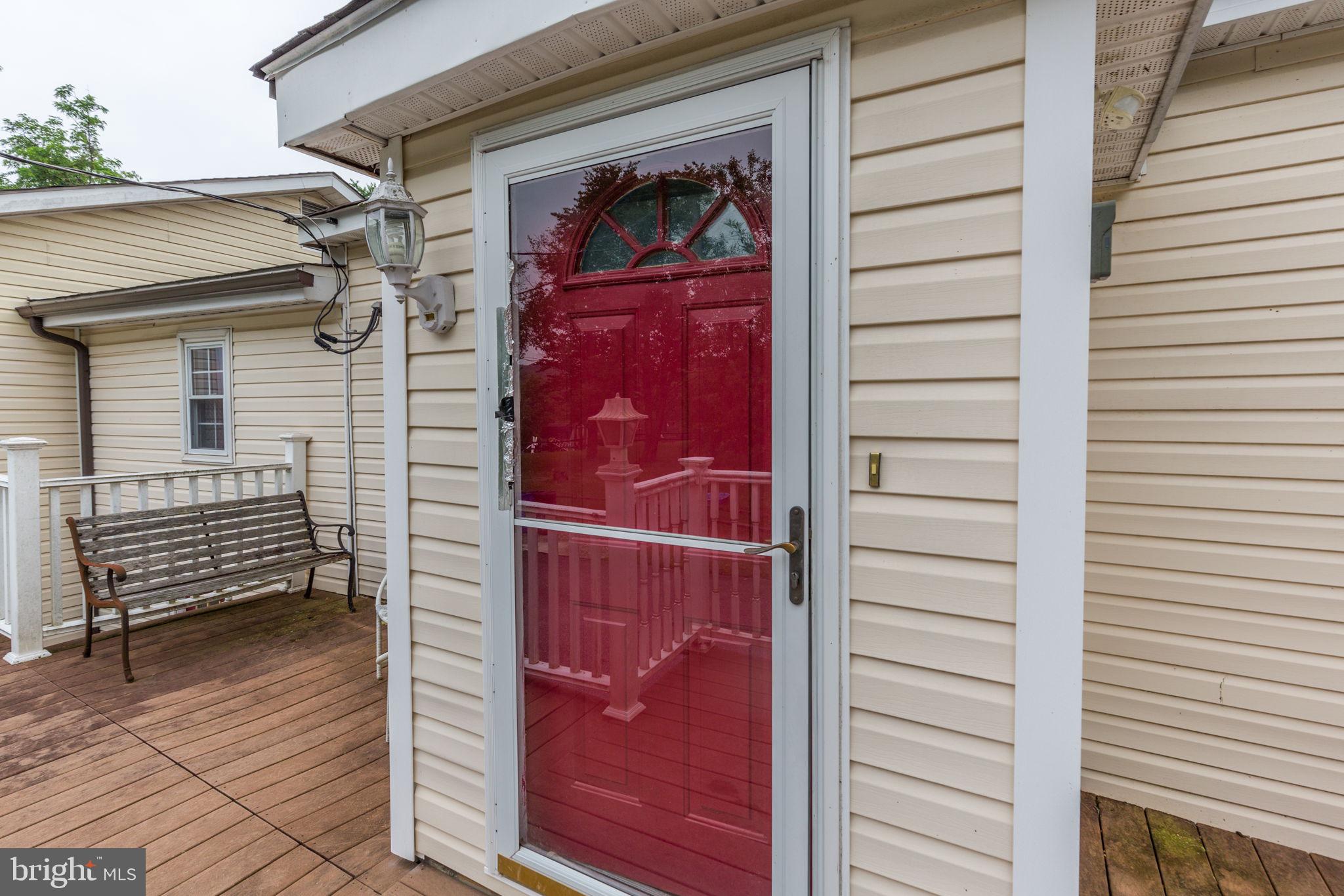 11907 Lime Plant Road New Market, MD 21774 - Photo 10 of 47 a view of a house with a door and wooden bench