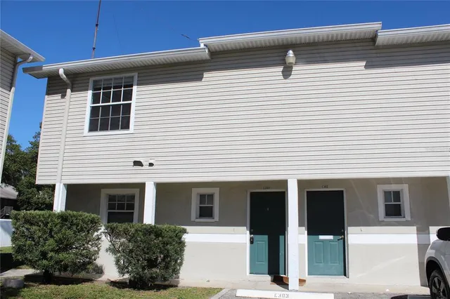a view of a white house with large windows