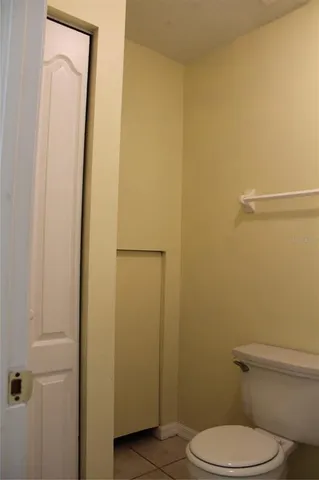 a white toilet sitting next to a shower