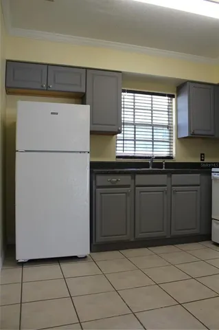 a kitchen with a sink a stove and cabinets