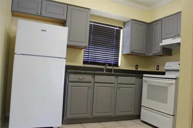 a kitchen with cabinets and white appliances