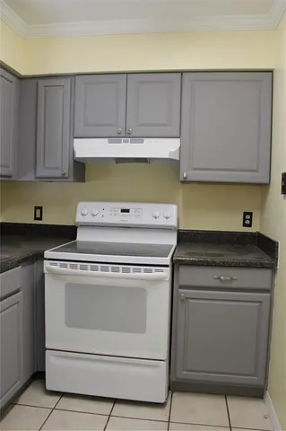 a stove top oven sitting inside of a kitchen
