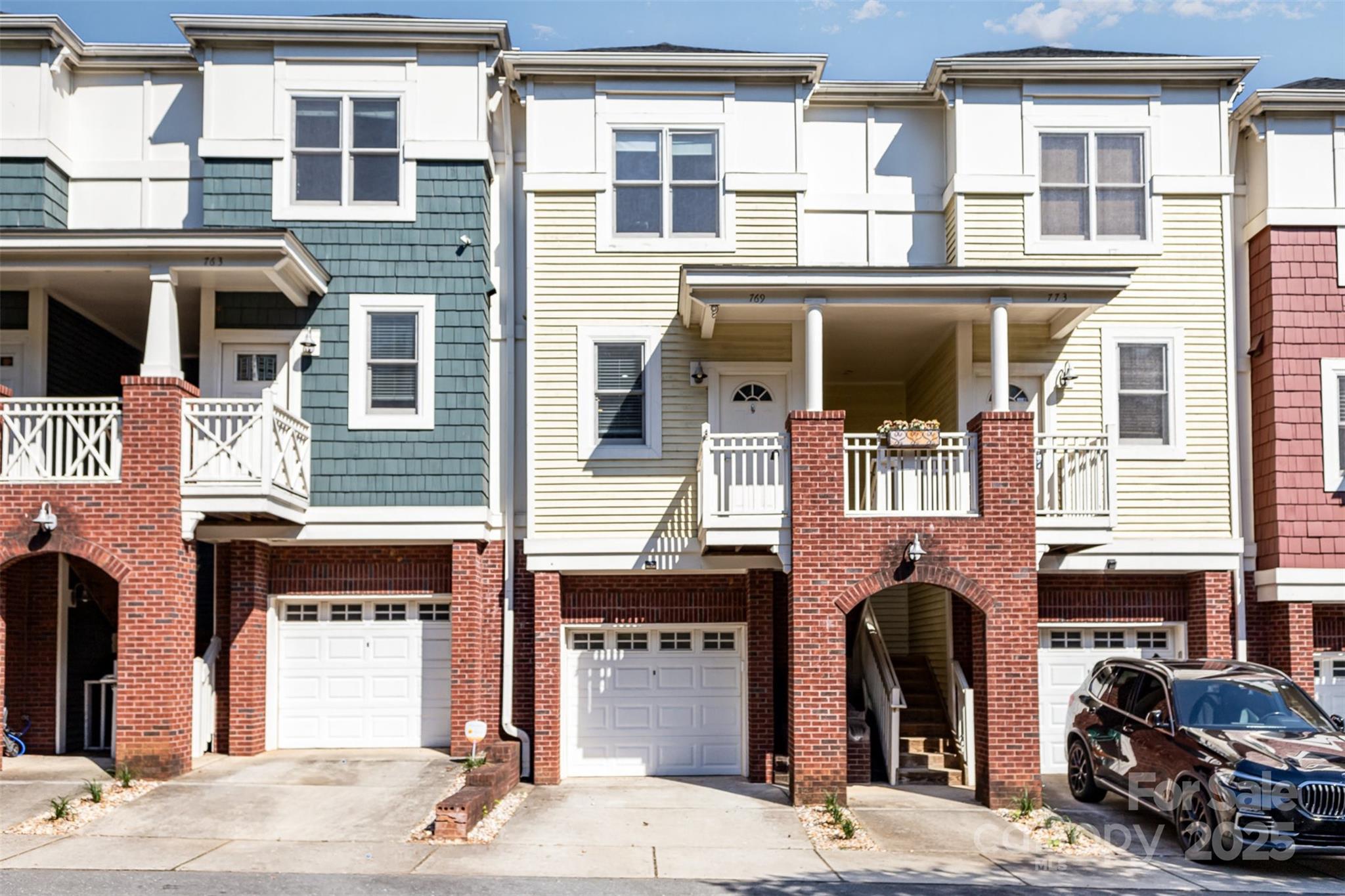 769 Grandin Road Charlotte, NC 28208 - Photo 2 of 17 a front view of a residential apartment building with a yard and balcony