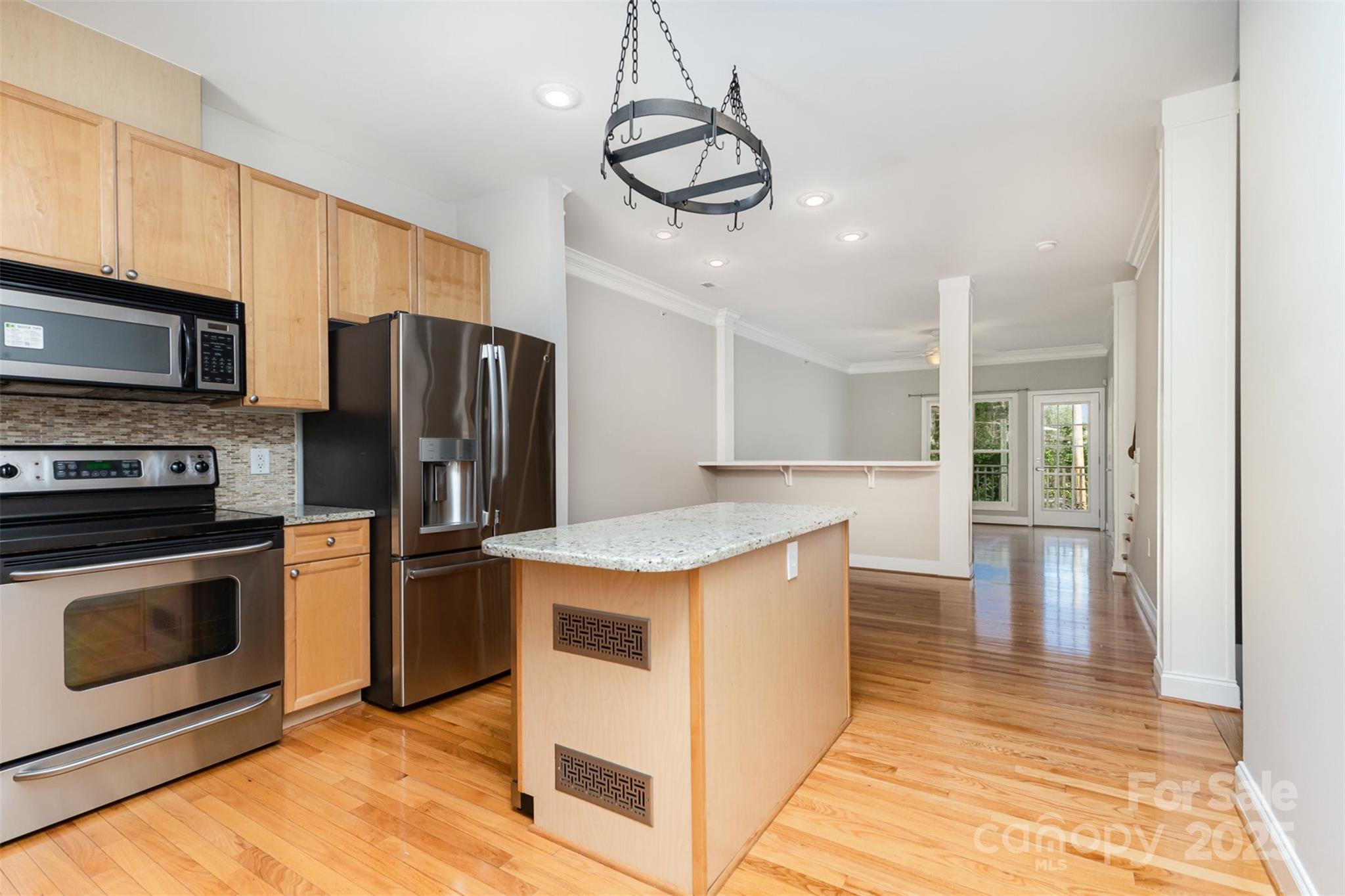 769 Grandin Road Charlotte, NC 28208 - Photo 3 of 17 a kitchen with stainless steel appliances granite countertop a kitchen island a stove a refrigerator a sink and a microwave