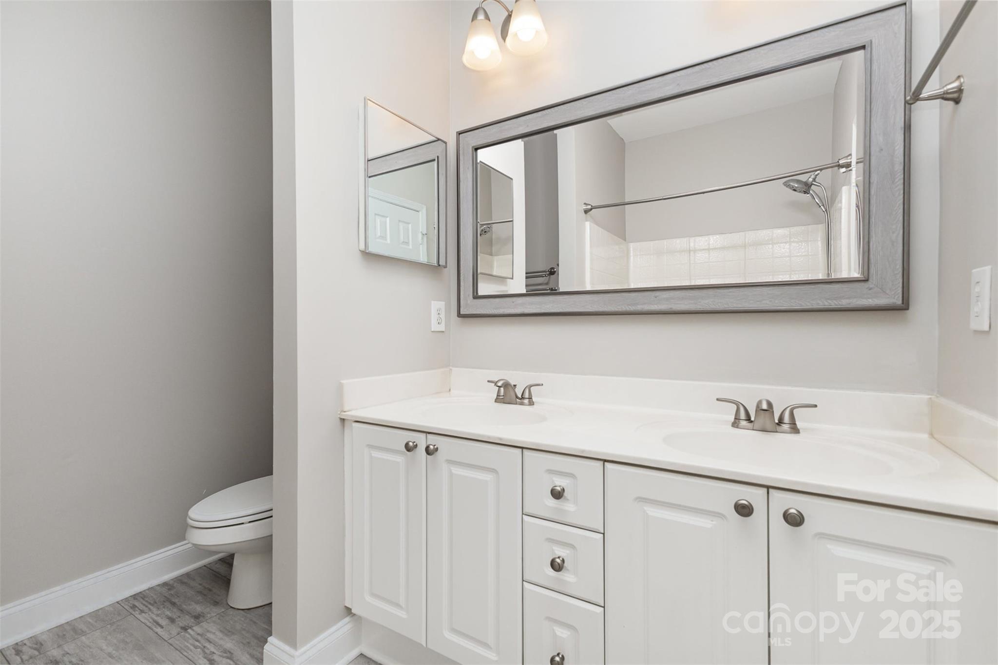 769 Grandin Road Charlotte, NC 28208 - Photo 9 of 17 a bathroom with a sink a toilet and a mirror