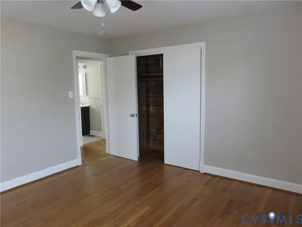 a view of an empty room with wooden floor