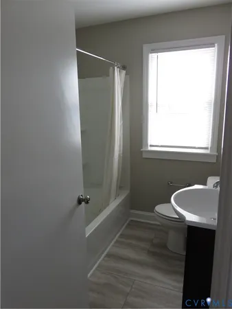 a bathroom with a sink toilet and tub