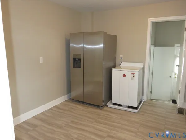 a view of a room with wooden floor