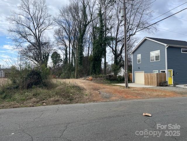 1815 Beatties Ford Road Charlotte, NC 28216 - Photo 6 of 14 a backyard of a house with large trees and outdoor seating