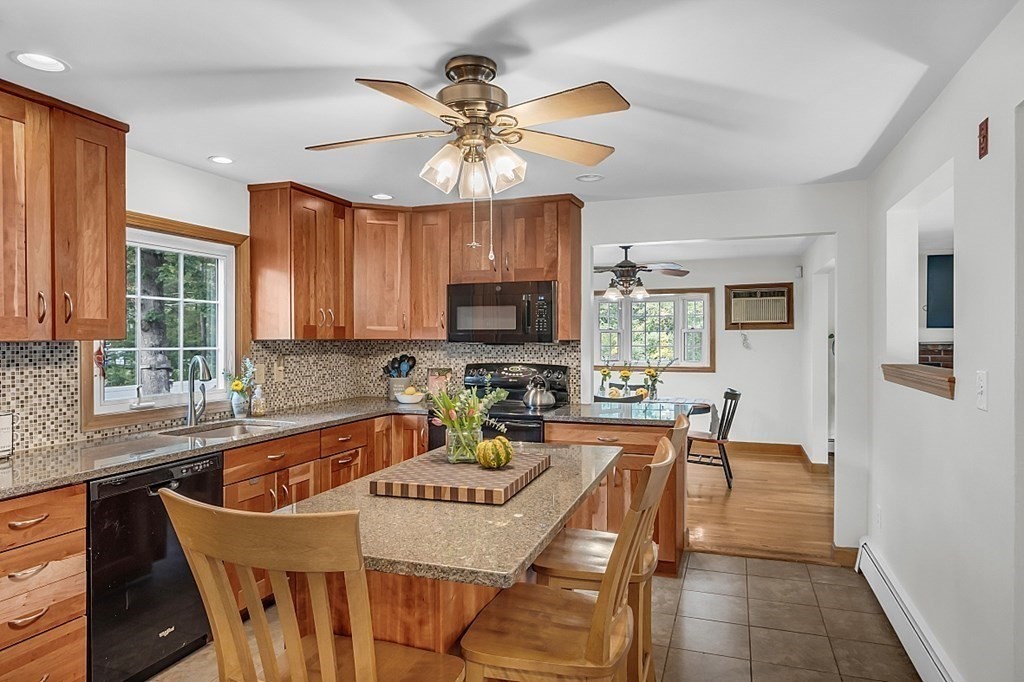 180 County Road Tewksbury, MA 01876 - Photo 11 of 40 a dining room with furniture a window and wooden floor
