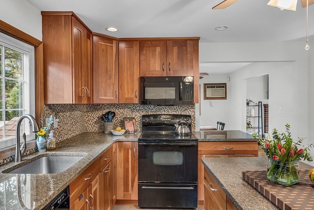 180 County Road Tewksbury, MA 01876 - Photo 13 of 40 a kitchen with a sink stove and microwave