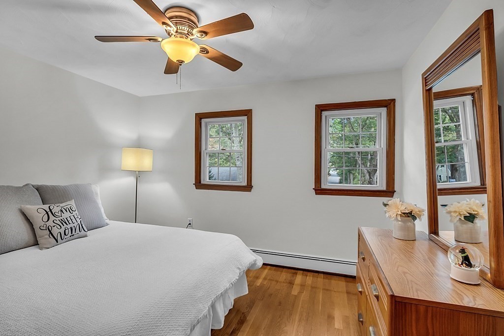 180 County Road Tewksbury, MA 01876 - Photo 20 of 40 a bedroom with a bed and a chandelier