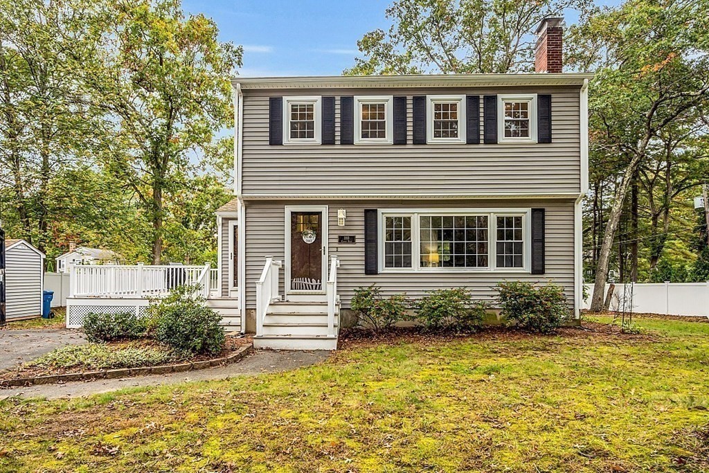 180 County Road Tewksbury, MA 01876 - Photo 2 of 40 a front view of a house with a yard