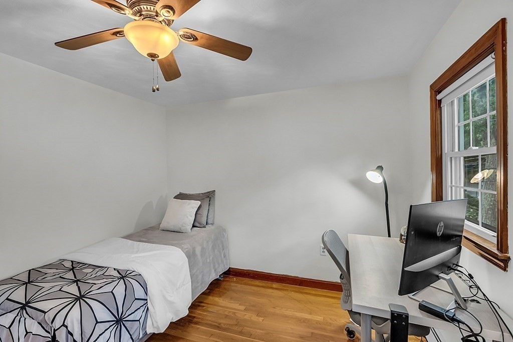 180 County Road Tewksbury, MA 01876 - Photo 23 of 40 a bedroom with a bed and a chandelier