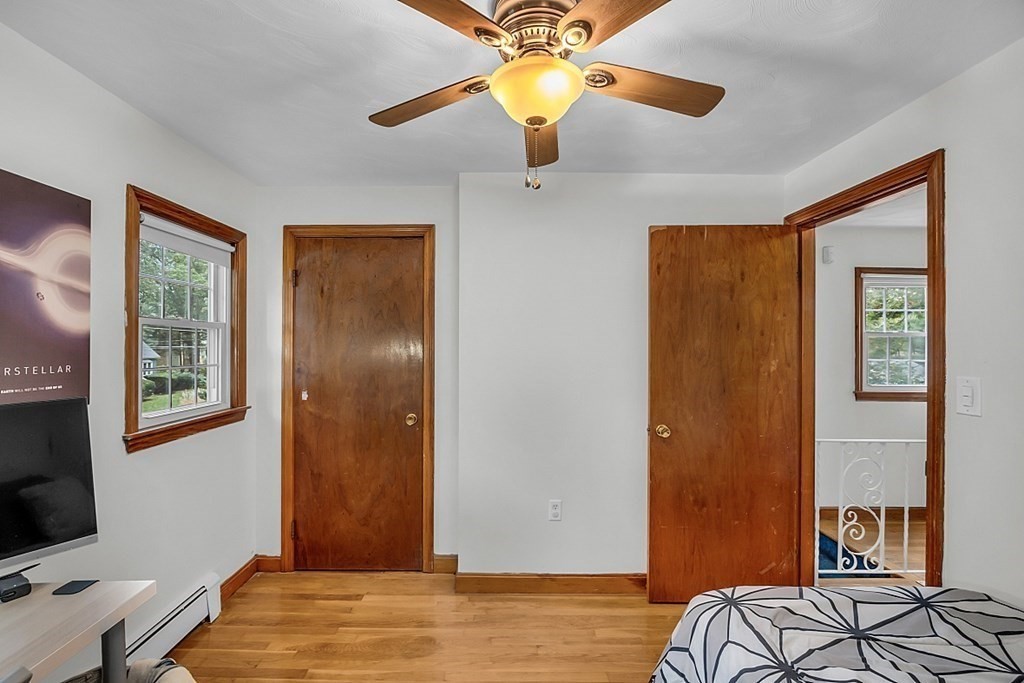 180 County Road Tewksbury, MA 01876 - Photo 25 of 40 a bedroom with a bed and a chandelier