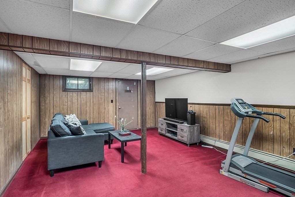180 County Road Tewksbury, MA 01876 - Photo 29 of 40 a living room with furniture and a flat screen tv