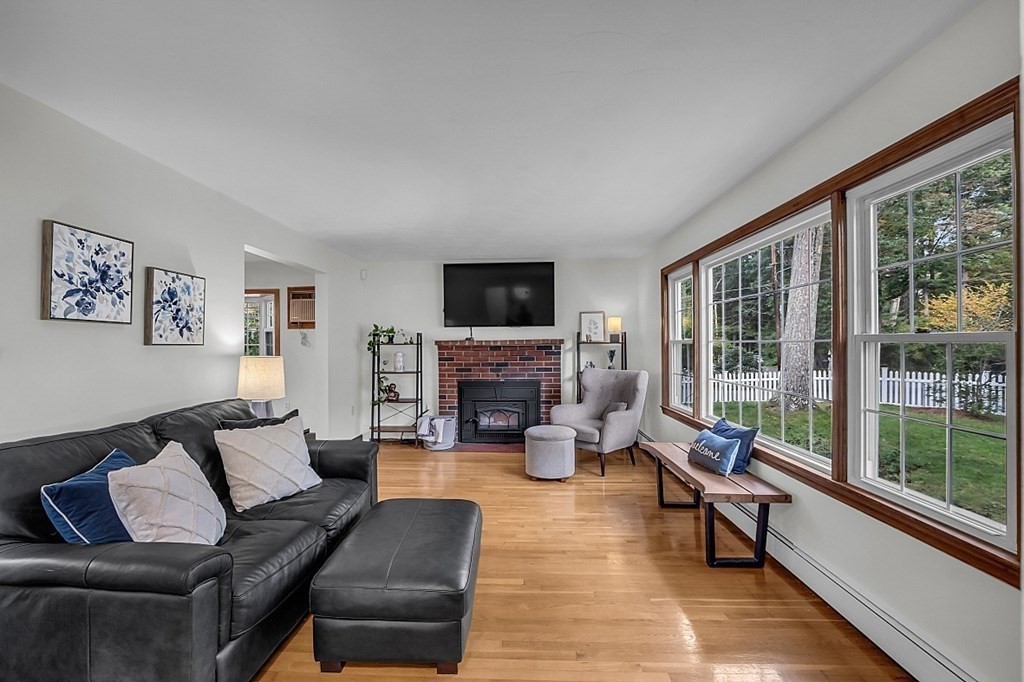 180 County Road Tewksbury, MA 01876 - Photo 4 of 40 a living room with furniture large window and a fireplace